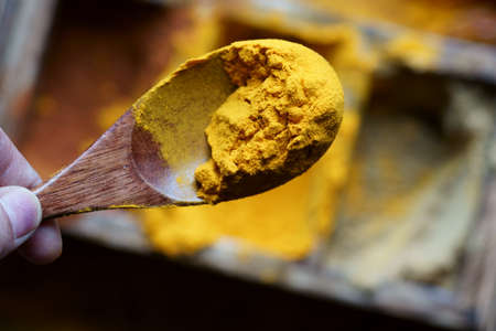 Close up of Indian spice Turmeric in a spoon.Turmeric powderの写真素材