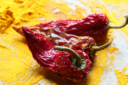 Close up of red Chiili peppers on Turmeric powderの写真素材