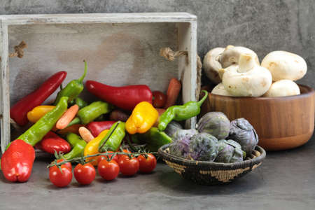 An assortment of Vegetables, of Brussels sprouts, mushrooms, peppers,carrots, tomatoes, green Shishito peppers, red peppers.の写真素材