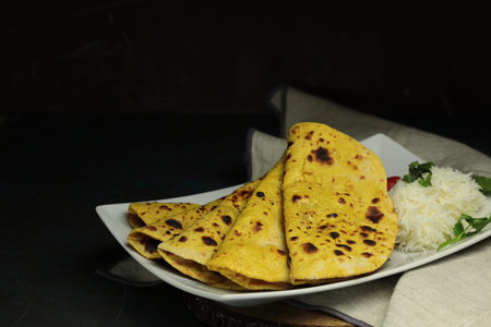 Home made Gluten free Chickpea flour Roti or Besan Roti or Chapati or bread on a plate .