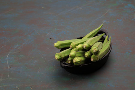 A bundle of fresh Lady's finger or Okra on wooden background with copy space.