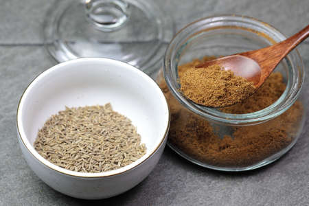 An Indian spice powder which is made of Roasted Cumin seeds in a jar on grey background.の写真素材
