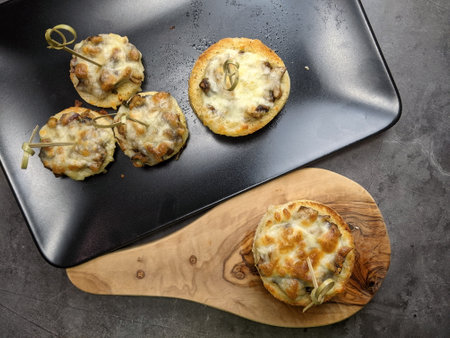 A platter of Cheesy Mushroom croustades or Cheesy Mushroom Discs toated for a starter or Hors d'oeuvreの写真素材