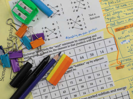A stack of papers with mathematical equations with school supplies.. Back to school concept.の写真素材