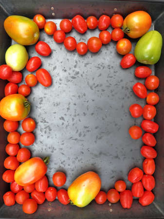 Cherry tomatoes with Roma Tomatoes on a grey background with copy space.の写真素材