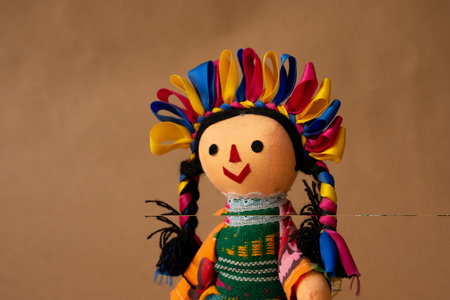 Colorful traditional Mexican doll, handmade by a member of an ethnic group called "Otomies". doll with braids and precious ribbons.の写真素材