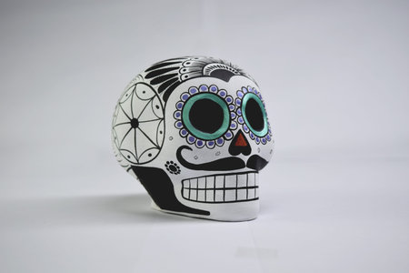 Beautiful and colorful Mexican skull isolated, made of ceramic, and painted by hand. Craft made in...