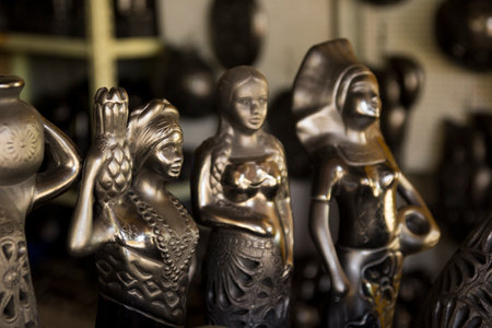 Ceramic figurines in a souvenir shop in Oaxaca, Mexico. Black traditional pottery from Mexico, Oaxaca. Lovely statue from Mexico.の写真素材