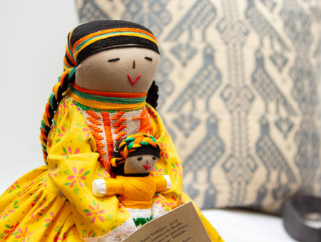 Mexican Dolls in traditional clothes on a white background. Selective focus. Hand-embroidered cushion and clothes.の写真素材