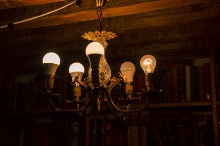 Vintage lamp in the dark room with bookshelf in the backgroundの写真素材