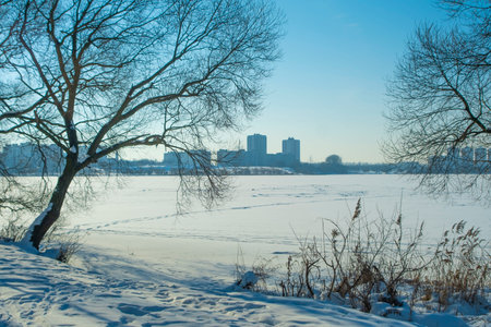 the lake is covered with ice in winterの写真素材