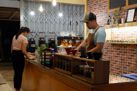 Kutai Barat, Indoensia - January 13, 2021: Professional coffee brewing staff in a beautiful and modern interiorのeditorial素材