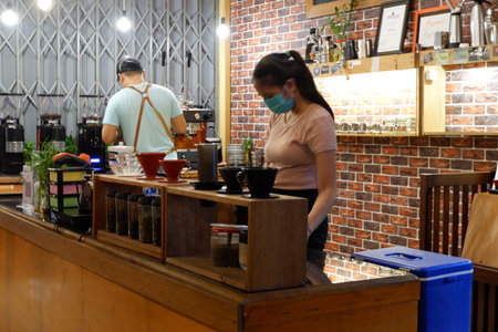 Kutai Barat, Indoensia - January 13, 2021: Professional coffee brewing staff in a beautiful and modern interiorのeditorial素材