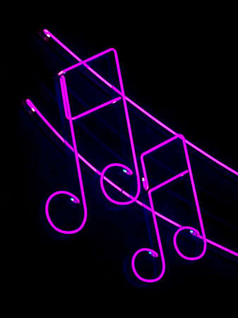 Neon musical note on black の写真素材