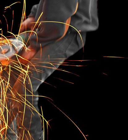 Worker, circular saw and sparks, isolated