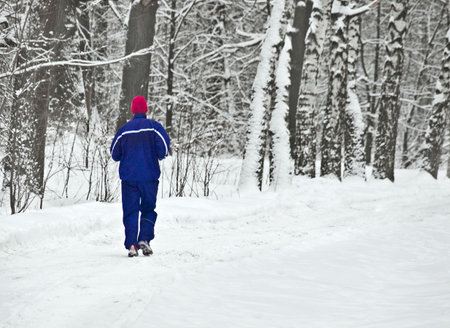 lone runner in wintry woodの写真素材