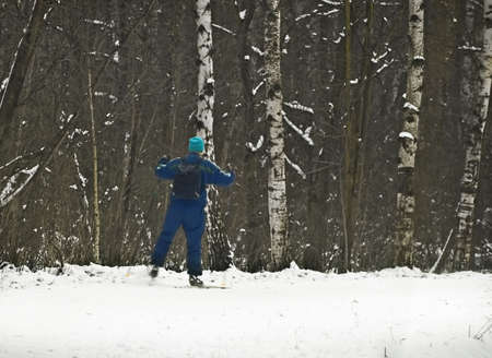 skier in winter forestの写真素材