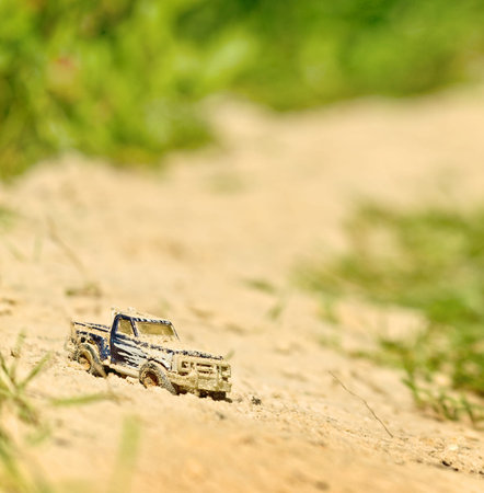toy SUV in sand (the tilt-shift)の写真素材