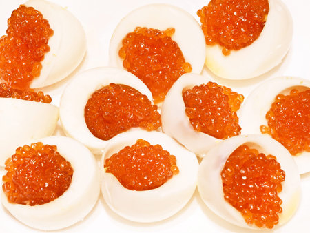 red caviar in boiled cut eggs - russian festive meal