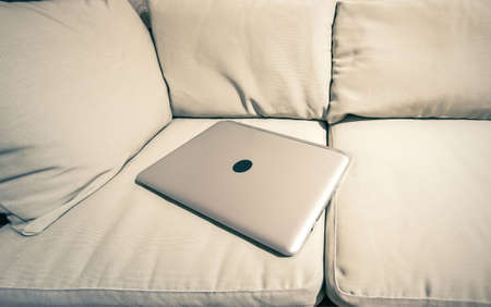 laptop on the couchの写真素材
