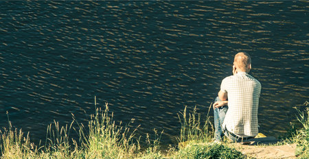 guy phone talking near water