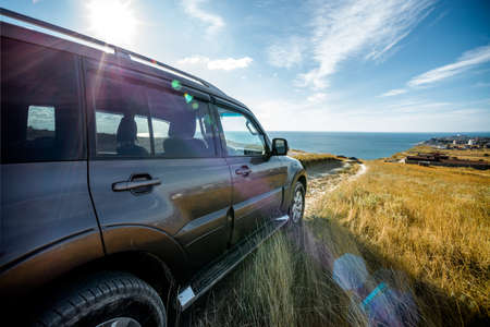 SUV moving down to the seaの写真素材