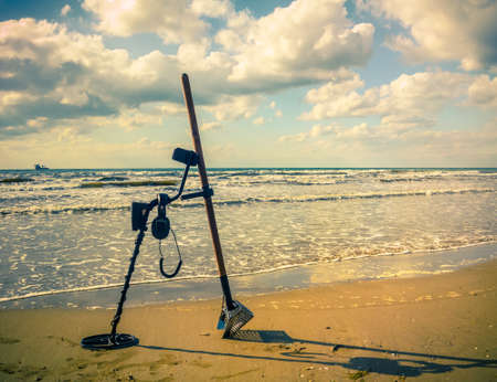 metal detector and sand scoop on the beach (changes)の写真素材