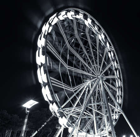 ferris wheel moving at nightの写真素材