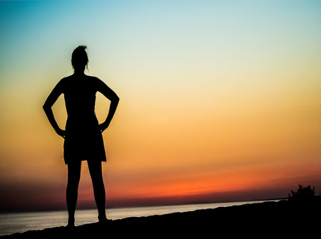 woman posing at sea sunset
