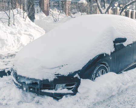 car in a snowy parkingの写真素材