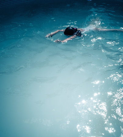 girl swims in dark pool