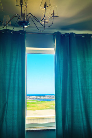 scenery views in semicurtained window の写真素材
