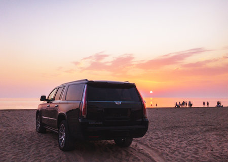 2020, Shevrolet Escalade on sandy beach at sunsetのeditorial素材