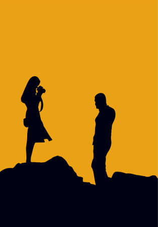 couple are photographing on sunset rocks, silhouetteの写真素材