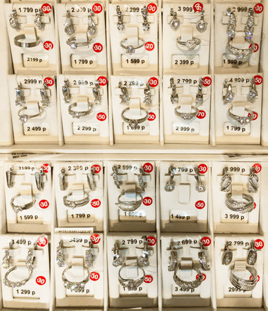 Russia 2020: white finger rings and ear rings sets are in jewelry showcase, closeupのeditorial素材