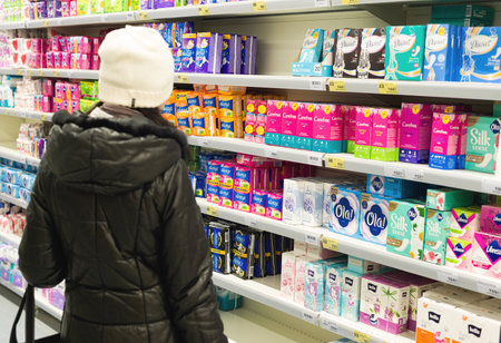 Moscow, Russia - March 18, 2020: woman chooses womens goods in supermarketのeditorial素材