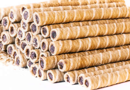 wafer- chocolate pipes isolated on whiteの写真素材