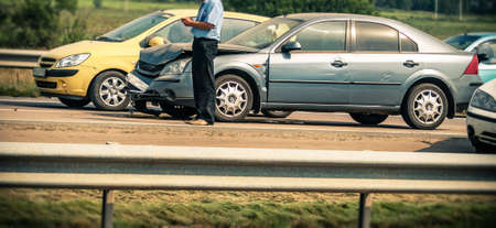 broken car and driver on highwayの写真素材