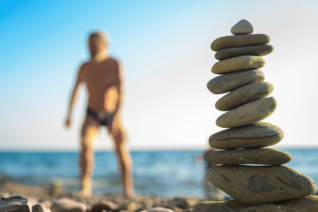 beach pebble stones pyramid on sea shore