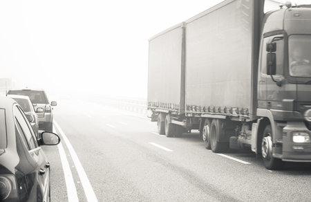 left-hand traffic highway at fogの写真素材