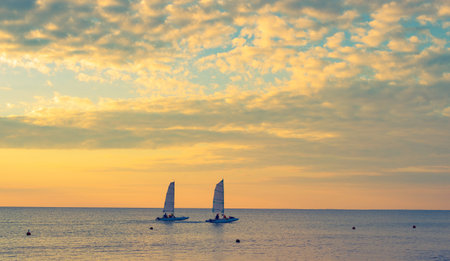 two catamarans in sunset sea
