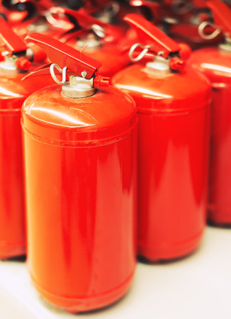 row of the fire extinguishers, on whiteの写真素材