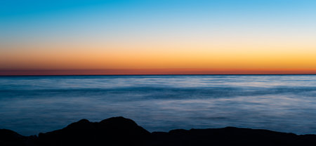 sea rocky coast at sunsetの写真素材