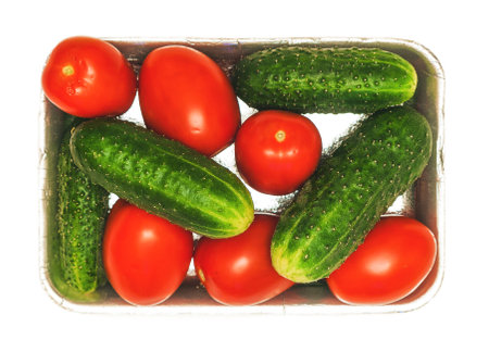 fresh cucumbers and tomatoes packedの写真素材