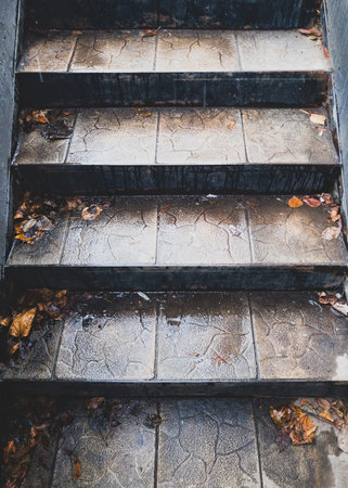 fallen leaves on a narrow stone staircaseの写真素材