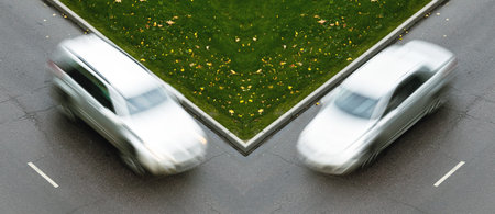SUV and sedan cars are rushing towards each other on the crossroad
