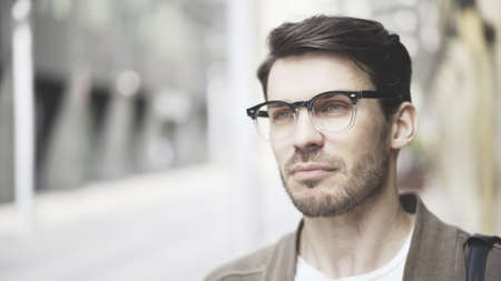 Handsome young man on the street thinking about future high tech project. Success and businesspeople concept.の写真素材