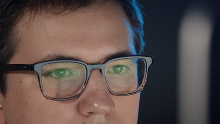 Closeup of man eyes in eyeglasses in front of the computer, gimbal pan shot right to left,...