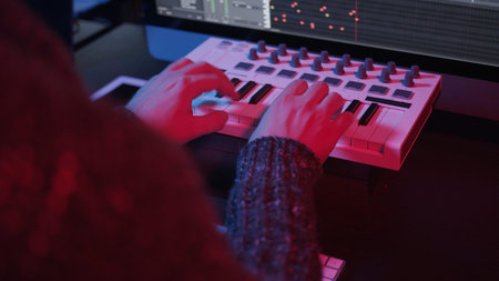 Recording music notes, playing electronic keyboard, midi keys in music sequencer. Hands and midi...
