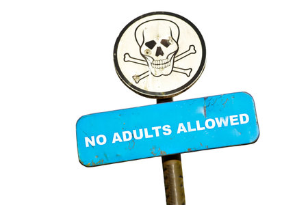 roadsign skull with bullet holes and text no adults allowedの写真素材